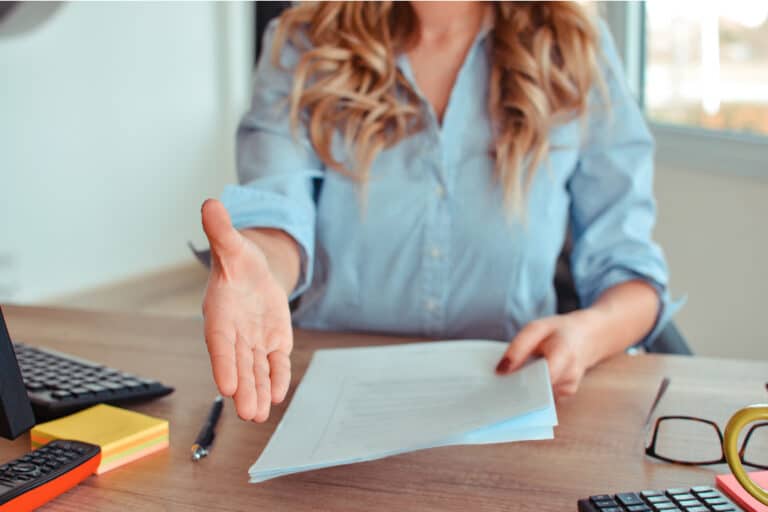 professional Travel Agent extending hand to shake after agreeing to work together on planning a vacation