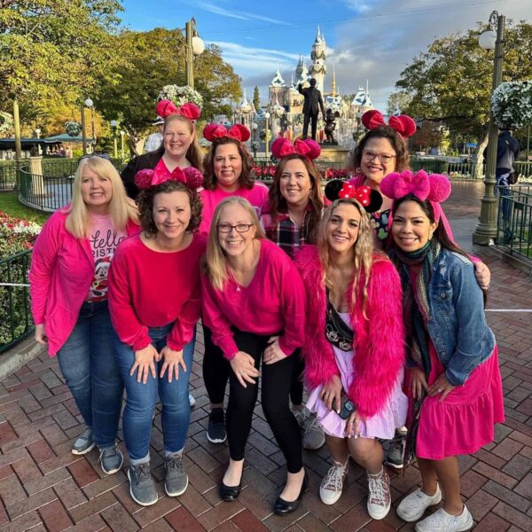 Travel Agents standing in front of Disneyland castle