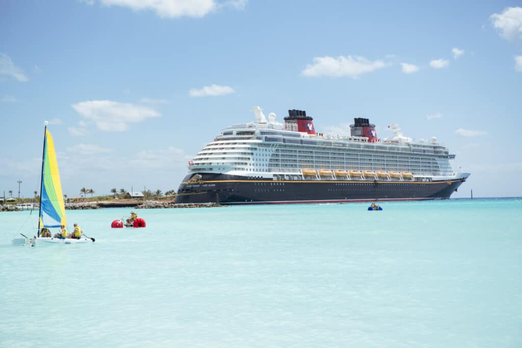 Disney Cruise Line ship docked at port in beautiful blue Caribbean waters