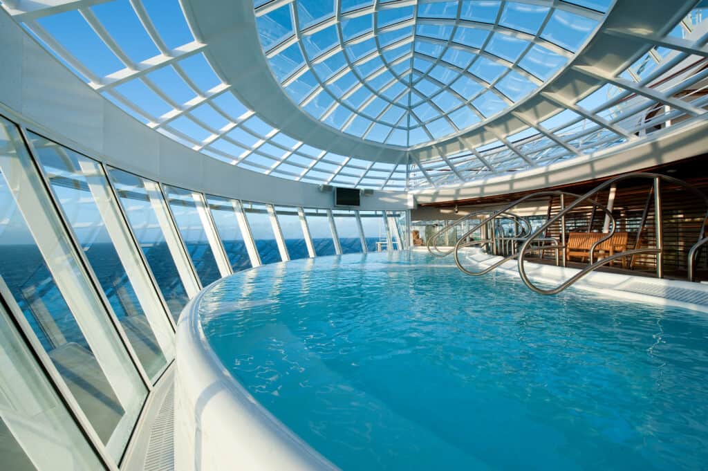 View of blue water pool inside Allure of the Seas Solarium on Royal Caribbean Cruise