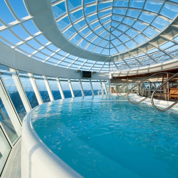 View of blue water pool inside Allure of the Seas Solarium on Royal Caribbean Cruise