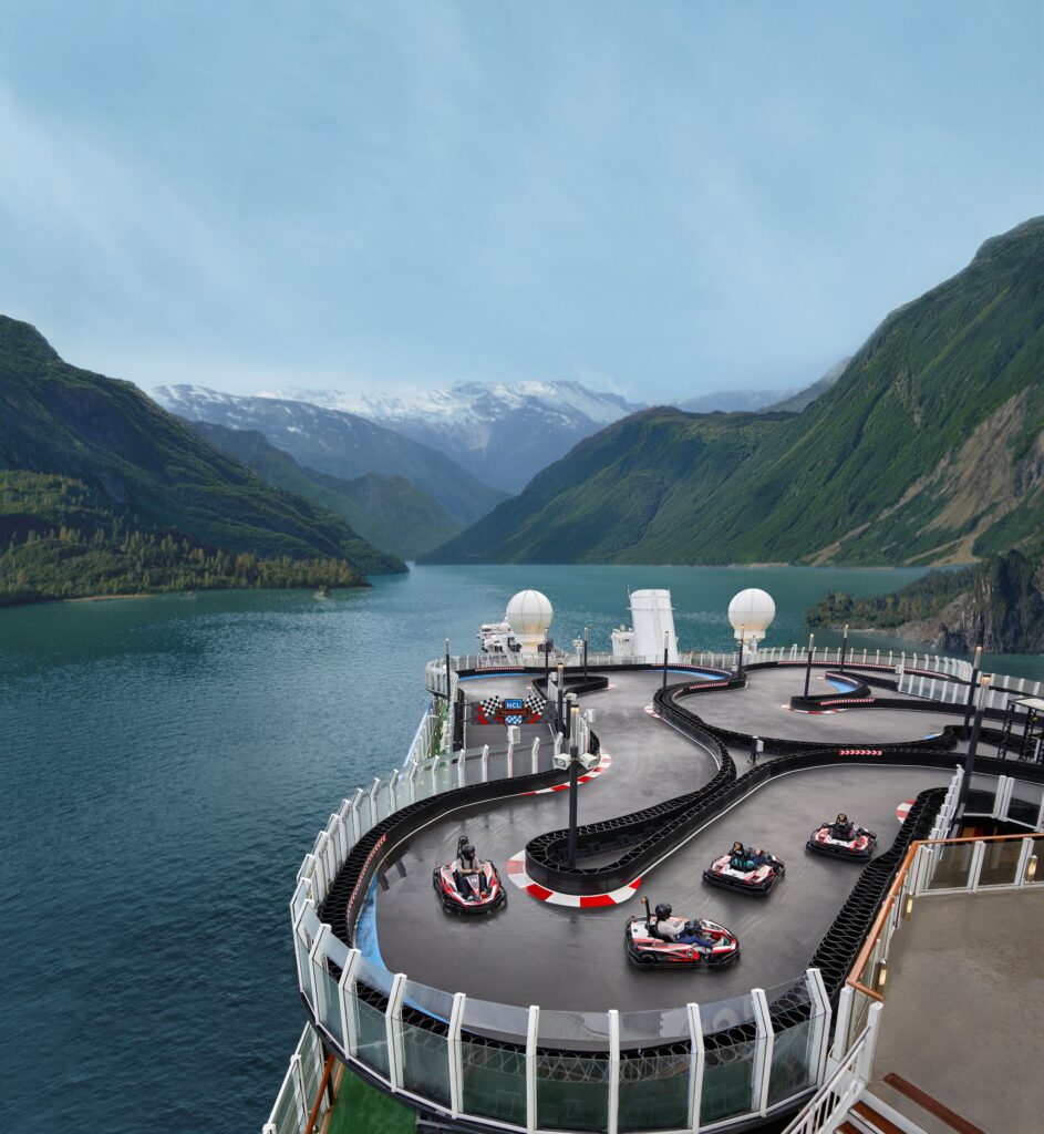 shot of NCL Bliss cruise ship with race car track against mountains in Alaska