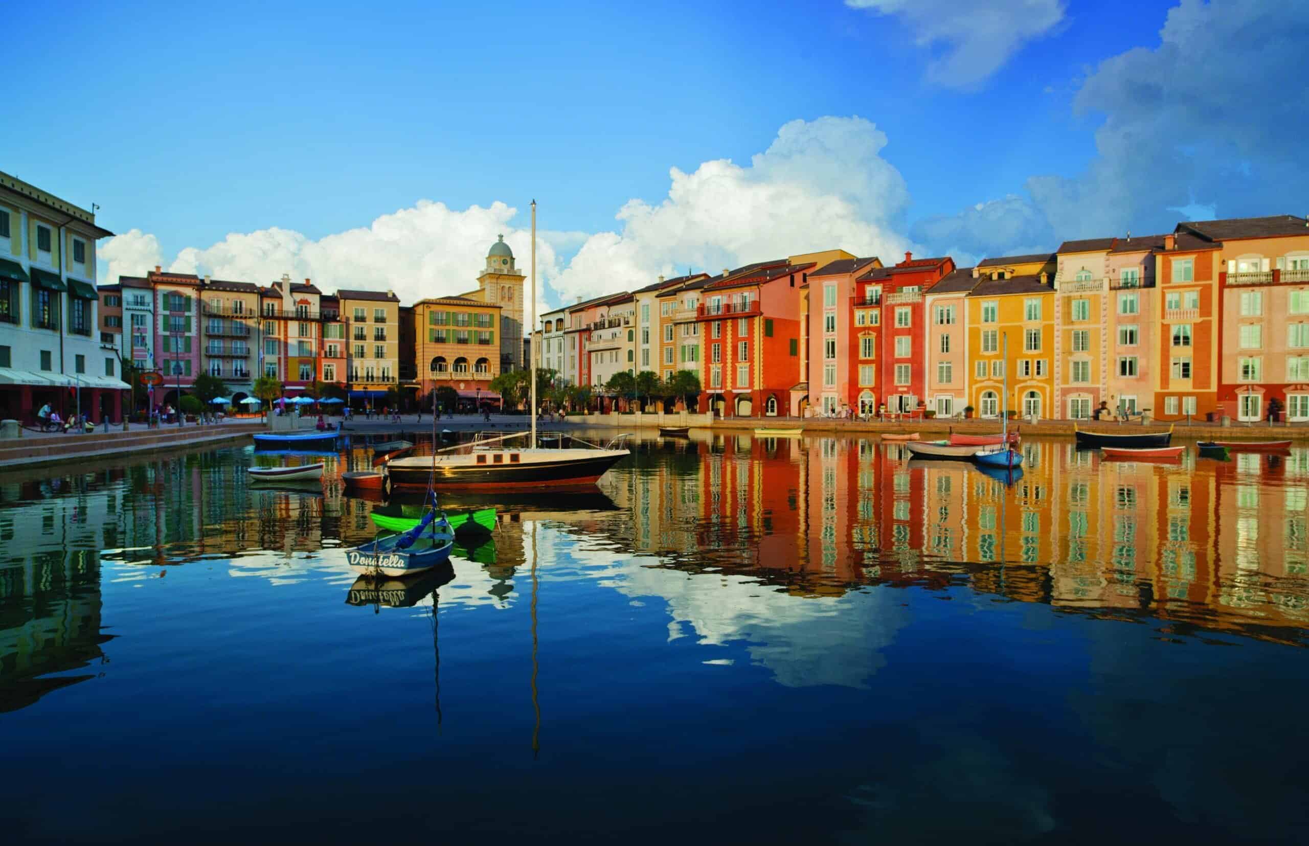 hotel in background with boat in waterway at Loews Portofino Bay Hotel