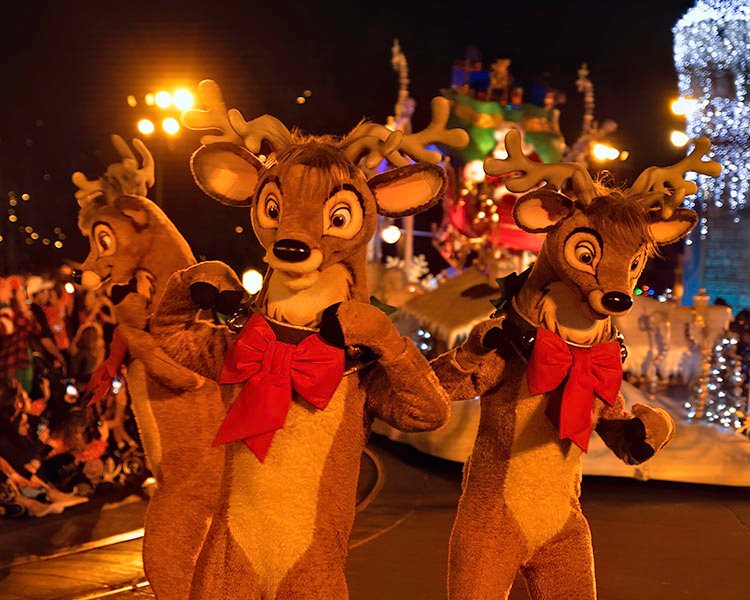 Reindeer performers dancing during parade route of Disney Christmas Party parade in WDW