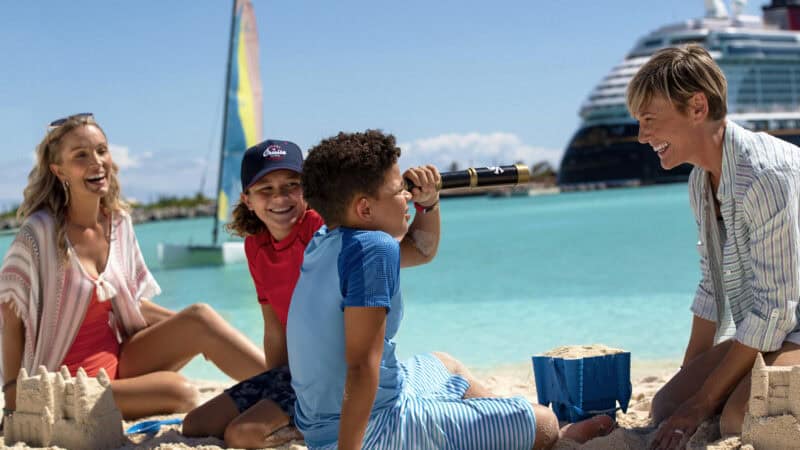 smiling family on beach at Castaway Cay