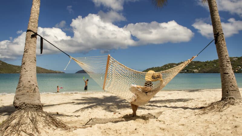 Woman sitting in Hammock on beach in St Thomas