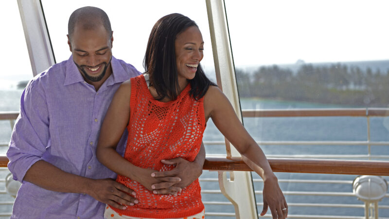 two adults on deck of Disney Cruise ship smiling