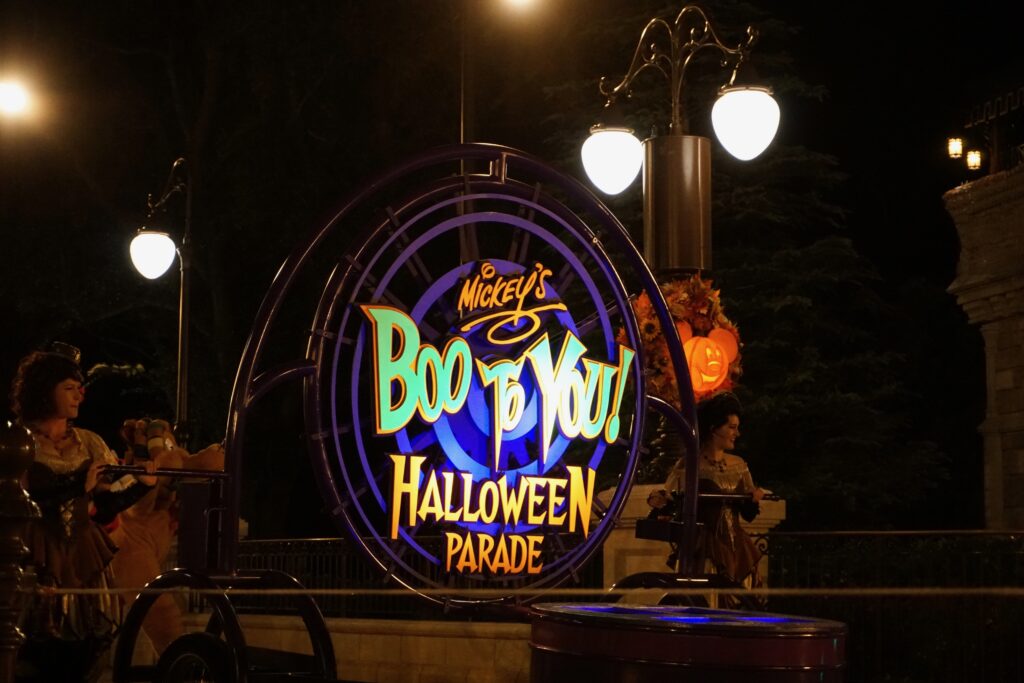 Sign on first float in Mickey's Boo To You Halloween Parade at Walt Disney World with vibrant colors