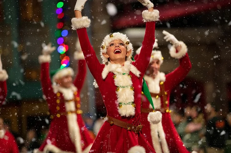 Christmas Parade performer in holiday attire performing at the Universal Orlando Holiday parade