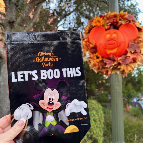 Image of the bag with words "Let's Boo this" written on it and contains an image of Mickey dressed in Halloween costume given to guests who purchase a Mickey's Not So Scary Halloween Party ticket to collect free candy at Trick or Treat Stations in Magic Kingdom