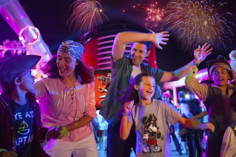 Family waving at pirates night deck party on a Disney Cruise ship