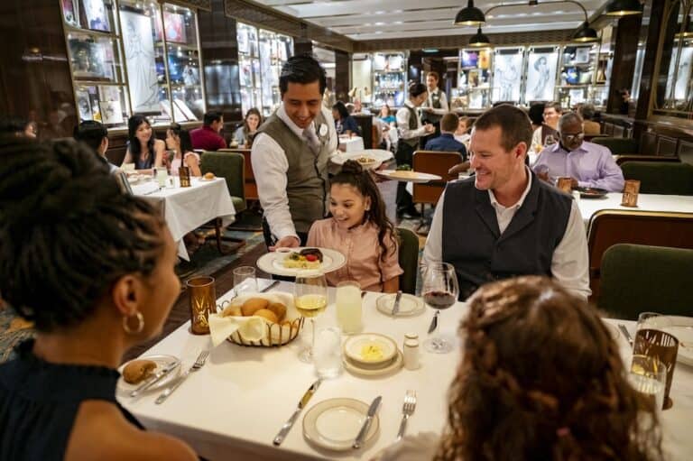 family eating dinner onboard the Disney Cruise ship, the Disney Wish
